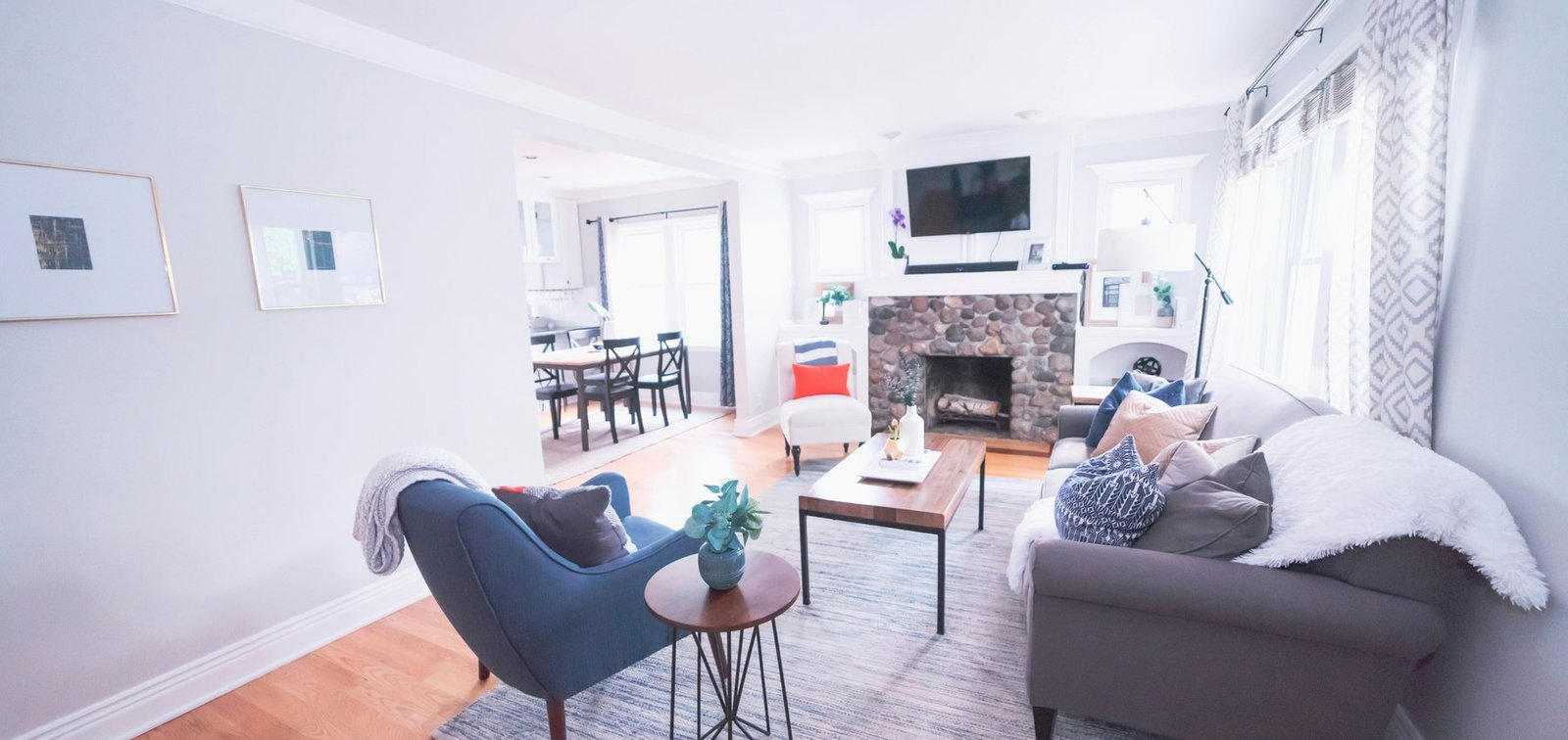 Professionally photographed bright living room with seating, dining space and clear sight lines, illustrating a property that can be understood before an in-person inspection.