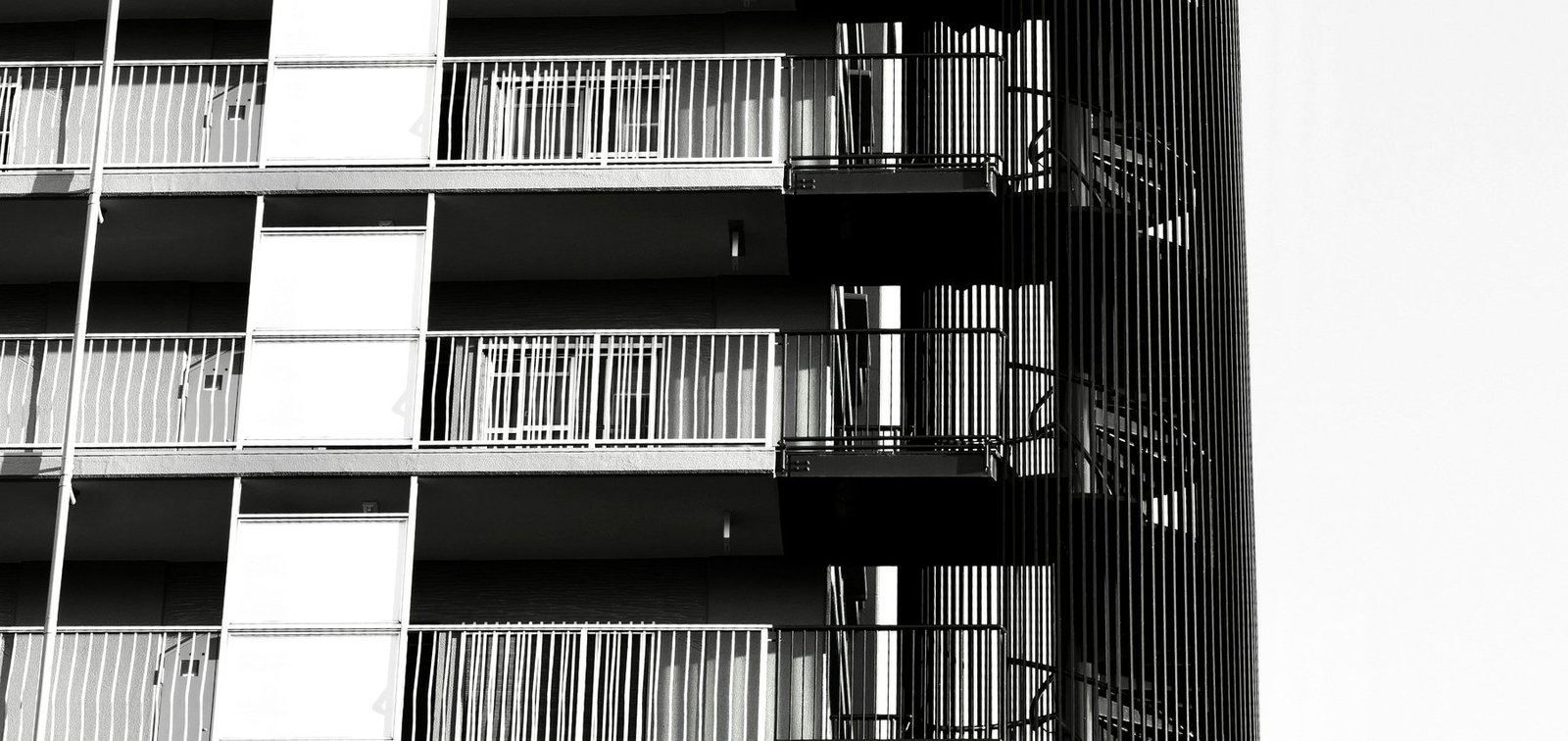Professionally photographed residential building facade with multiple visible access points, reinforcing the need to report information that appears unsafe or misleading.
