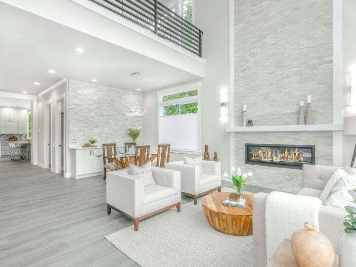 Professional photograph of a bright open-plan modern apartment with white seating, a fireplace and large windows; representative demo image for the East Legon apartment Gallery image 3 of 5 for Professional Office Suite in Anaji, Takoradi.