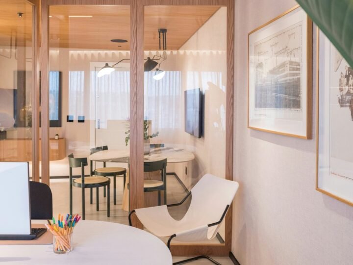 Professional photograph of a refined office meeting space with glass partitions, desks and warm timber finishes; representative demo image for the Anaji office suite Gallery image 1 of 5 for Professional Office Suite in Anaji, Takoradi.
