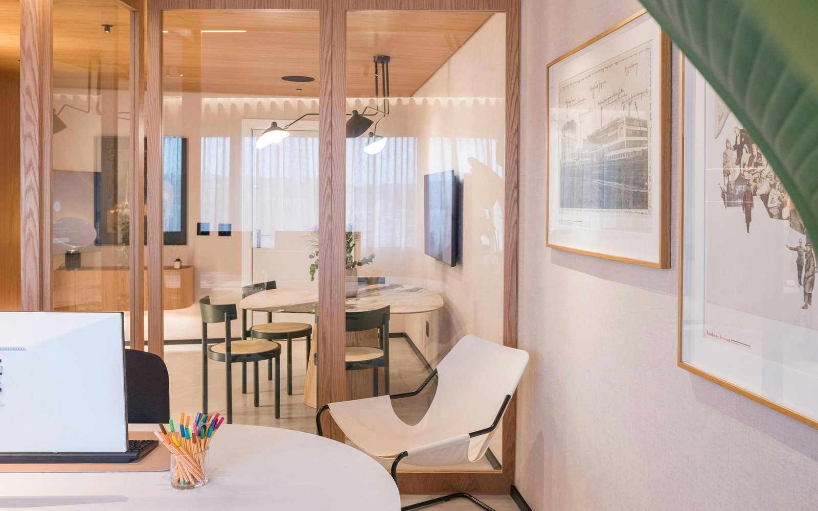 Professional photograph of a refined office meeting space with glass partitions, desks and warm timber finishes; representative demo image for the Anaji office suite Gallery image 1 of 5 for Professional Office Suite in Anaji, Takoradi.