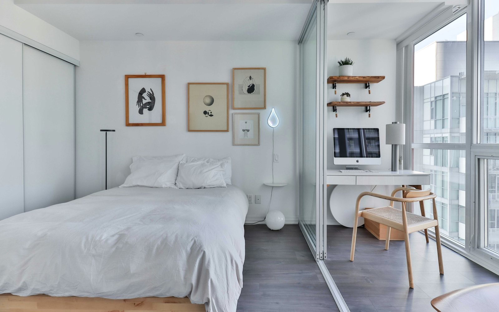 Professional photograph of a neat self-contained bedroom with a bed, desk, shelving and balcony light; representative demo image for the Pedu room Gallery image 1 of 5 for Neat Self-Contained Room at Pedu, Cape Coast.